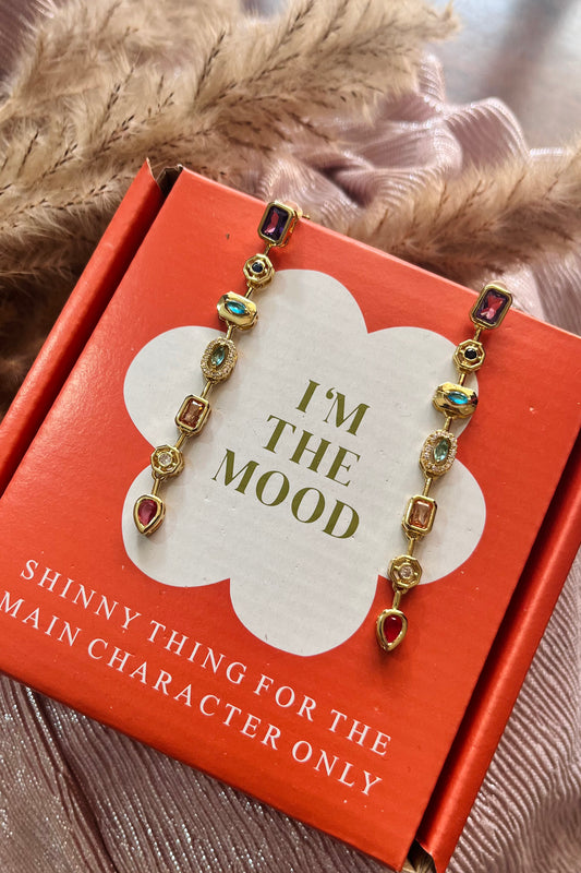 Bracelet on a box with 'I'm the Mood' text and decorative elements.